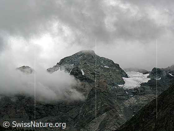 Foto: Schwarzhorn bei Schlechtwetter. Mit Wolkenfetzen/Nebelfetzen in der Nordflanke des Schwarzhorns. Rechts der Schwärzegletscher.